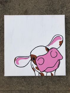 a sticker with a cow painted on it's face in pink and brown