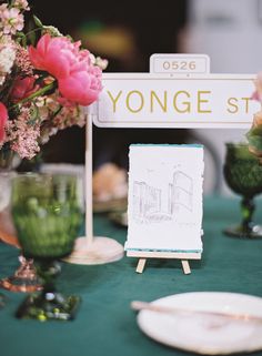 there is a sign that says yonge st on it and flowers in vases