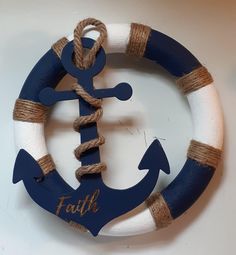 a blue and white life preserver with an anchor on it's side that says faith