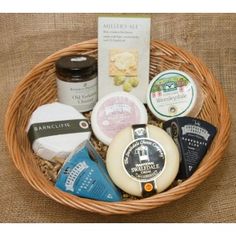 a basket filled with different types of cheese