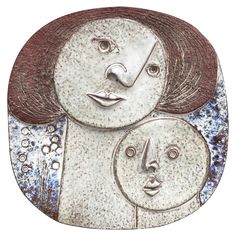 a ceramic plate with two faces on it