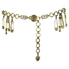 Presenting an extremely rare gold-tone Gianni Versace safety pin chain belt designed by Gianni Versace. From the Spring/Summer 1994 collection, this rhinestone accented belt debuted on the season's runway as part of Look 82, modeled by Christy Turlington Burns. This belt features a Greek key chain and is complete with clusters of gold safety pins. The safety pin, a Versace house code, was made infamous when worn by Elizabeth Hurley and has been reused in more recent collections by Donatella. If Versace Chain Belt, Versace House, Versace Safety Pin, Medusa Versace, Versace Chain, Gold Chain Belt, Versace Gold, Elizabeth Hurley, Luxe Jewelry