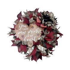 a heart shaped wreath with the words you don't paw prints on my heart