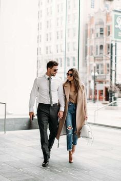 a man and woman are walking down the street