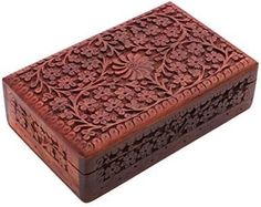 an intricately carved wooden box on a white background