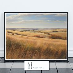 an oil painting of a field with trees and clouds in the background, on a wooden floor