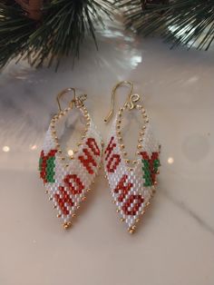 the beaded earrings are hanging from the christmas tree