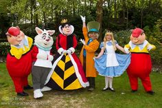 several people dressed in costumes posing for a photo