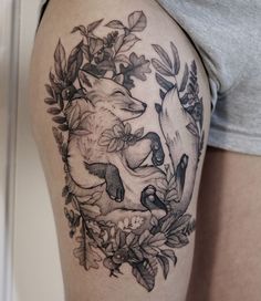 a woman's thigh with an animal tattoo on it