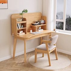 a wooden desk sitting next to a window in a room with hardwood floors and white walls