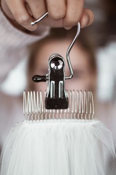 a person holding a hair comb over their head