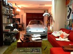 a living room filled with furniture and a car