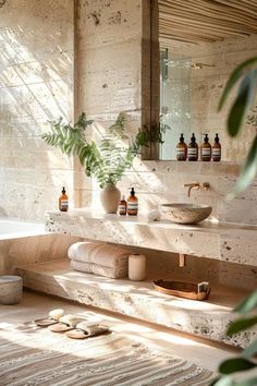 a bath room with a tub a sink and some bottles on the counter next to it