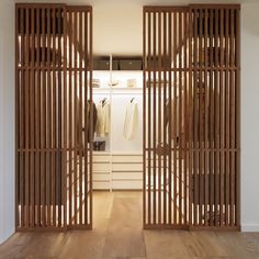 an open closet with wooden slats on the doors