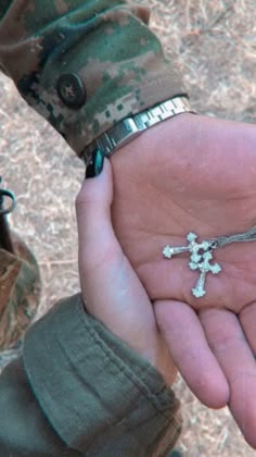 a person holding a cross in their hand