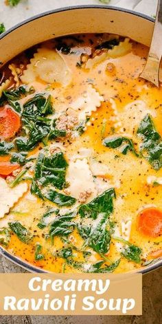 creamy ravioli soup with spinach and carrots in a large pot on the table