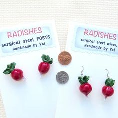 three small red radishes are sitting next to each other on a piece of paper