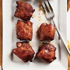 chicken wings on a white plate with a fork