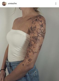 a woman's arm with flowers on it, and the top half of her sleeve