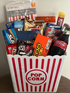 a popcorn bucket filled with snacks and drinks