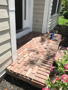 a brick walkway in front of a house