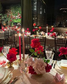 the table is set with flowers and candles