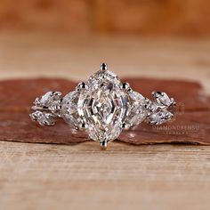 a diamond ring sitting on top of a wooden table