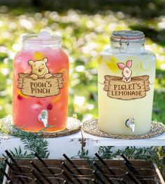 two jars filled with liquid sitting on top of a table