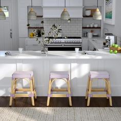 two stools are sitting in front of the kitchen counter