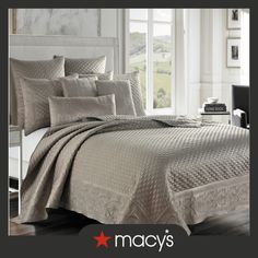 an image of a bed in a room with white walls and wood flooring that has the macy's logo on it