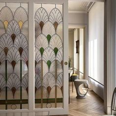 a glass door with an art deco design in the center and side panels on both sides