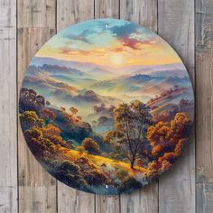 a painting on the side of a wooden fence with mountains in the distance and trees