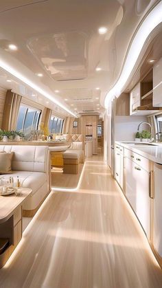 the interior of a luxury jet with wood flooring and white furniture, along with windows