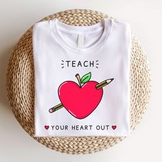 a t - shirt that says teach your heart out with an apple and pencils on it