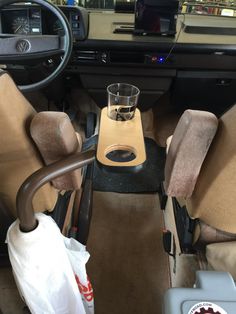 the interior of a car with two seats and a drink holder