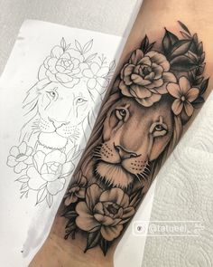 a lion and flowers tattoo on the arm