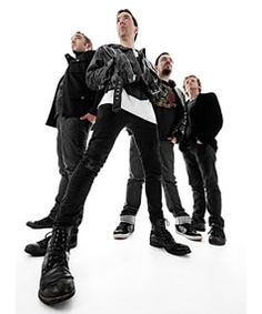 a group of young men standing next to each other in front of a white background