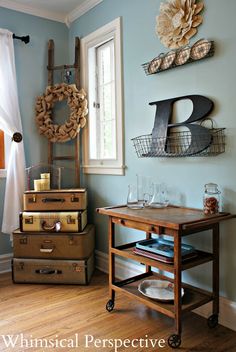 three suitcases stacked on top of each other in a room with blue walls and wood floors