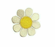 a yellow and white flower with four petals on the center is embroidered onto a white background