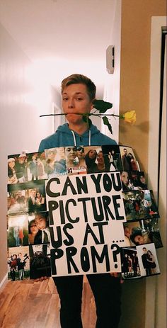 a man holding a sign that says can you picture us at prom?