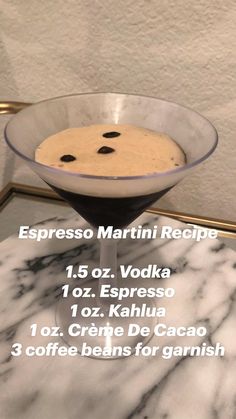 a dessert in a glass bowl on a marble table