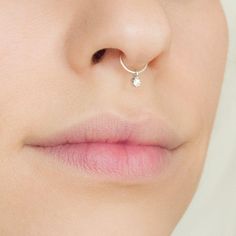 a woman with a nose ring on her nose