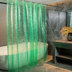 a green shower curtain in a bathroom next to a bathtub and table with a vase on it