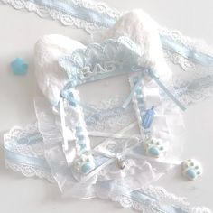 a white and blue teddy bear hat on top of a lace garter with beads