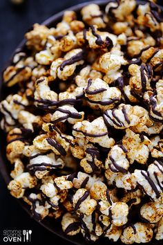 a bowl filled with popcorn covered in chocolate