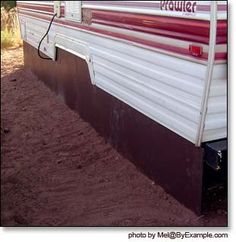 an rv parked on the side of a dirt road