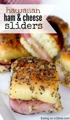 ham and cheese sliders on a white plate with text overlay that reads hawaiian ham and cheese sliders