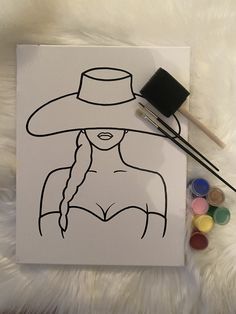 a drawing of a woman wearing a hat and holding a paintbrush next to it