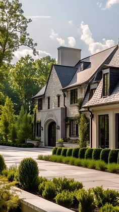 a large house with lots of windows and bushes