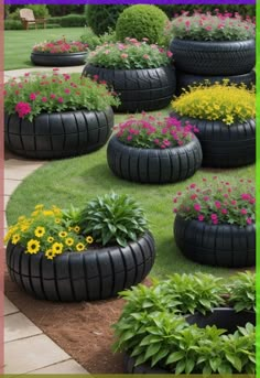 an assortment of tires and flowers in a garden